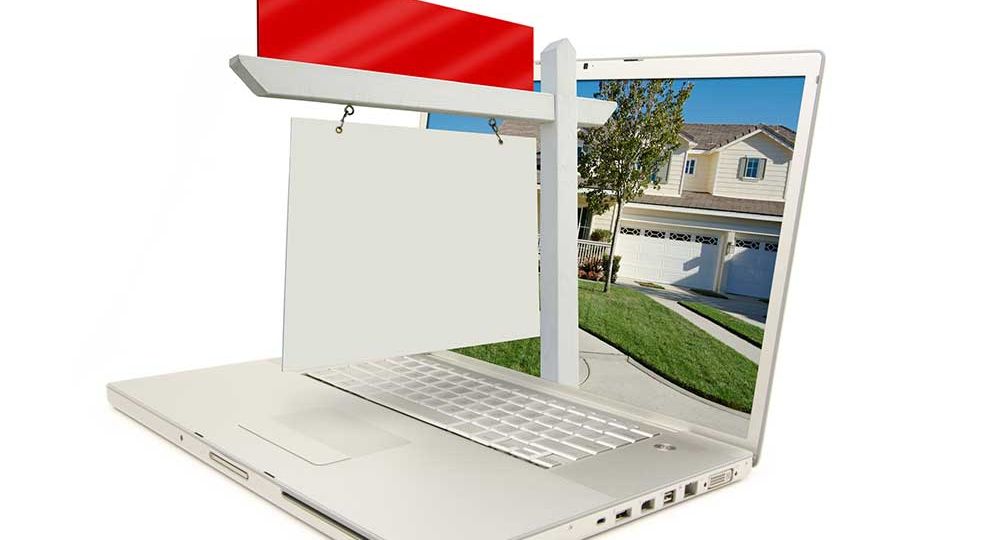 Laptop with real estate sign coming out of it